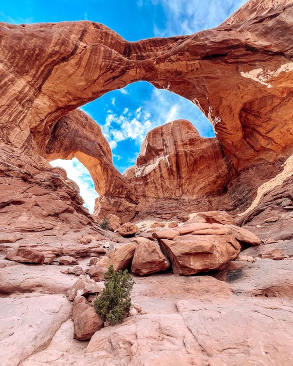 Sandstone natural arch formation against a blue sky