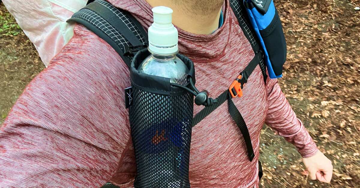 daypack and water bottle at a trailhead