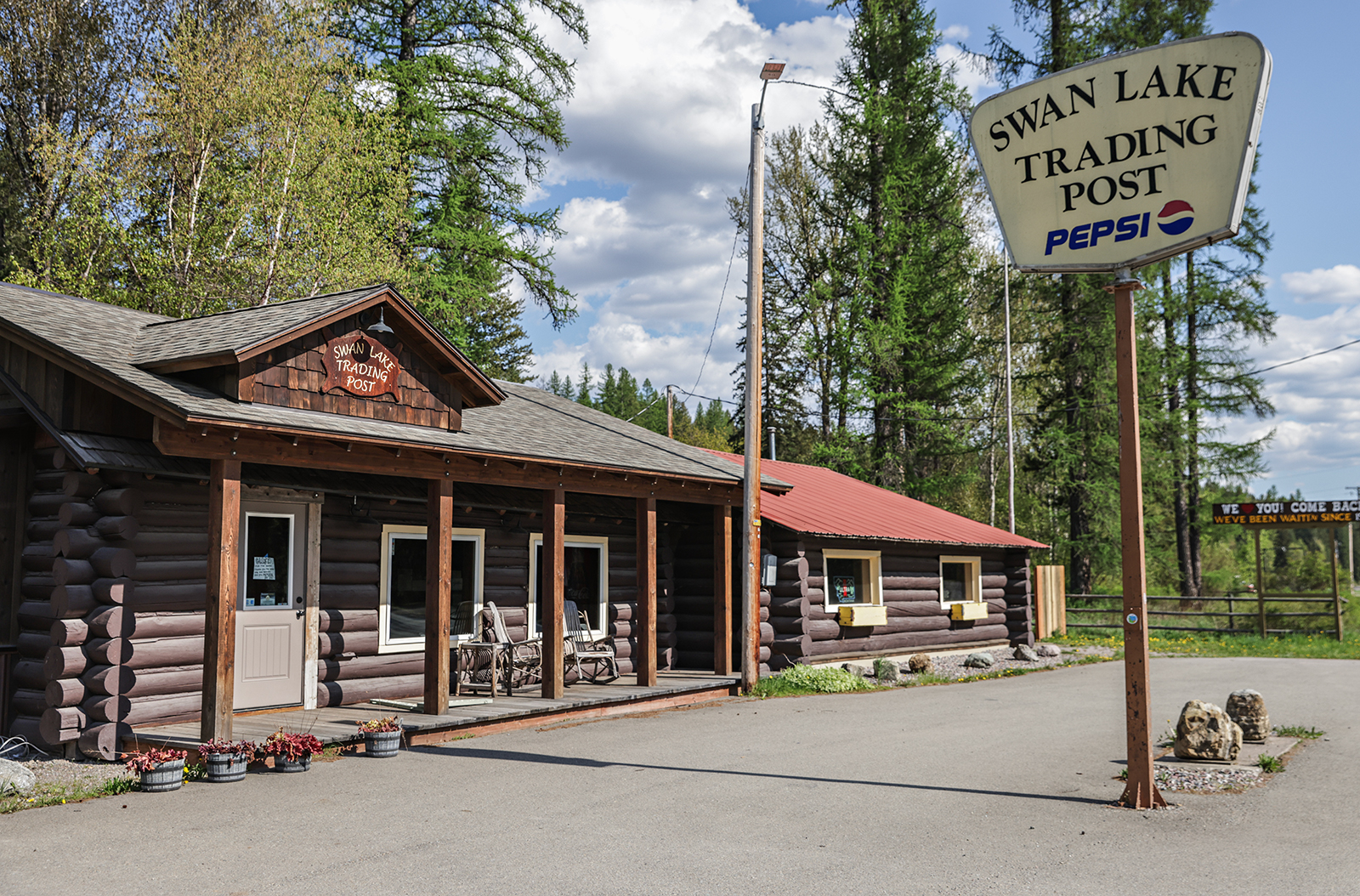 Old wooden trading post building along a mountain highway